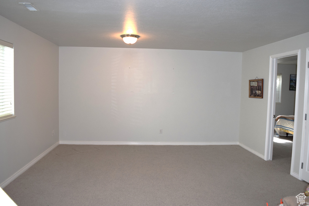 Empty room with carpet and baseboards