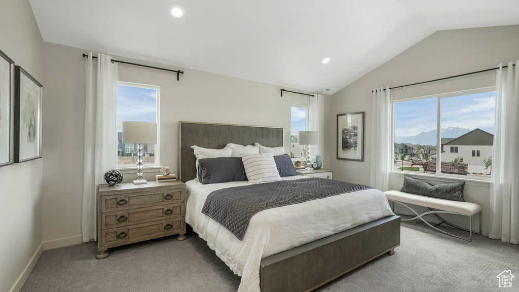 Bedroom featuring multiple windows, lofted ceiling, light colored carpet, and recessed lighting