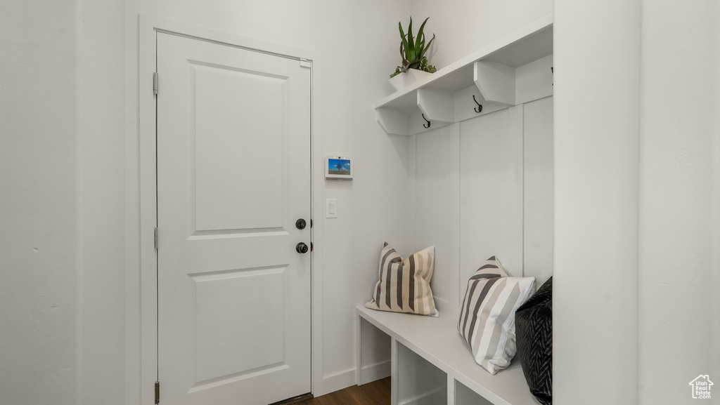 Mudroom with dark wood-style flooring and baseboards