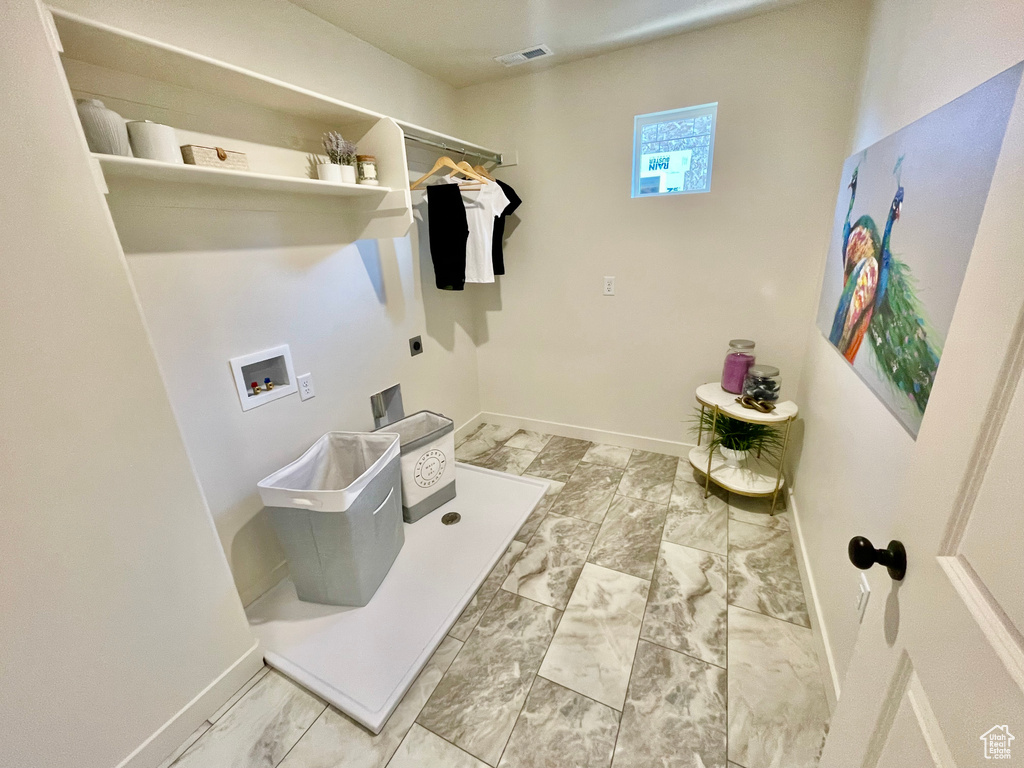 Laundry room featuring hookup for an electric dryer, hookup for a washing machine, baseboards, and marble look tile flooring