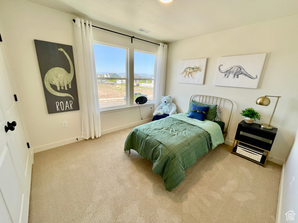 Carpeted bedroom with baseboards