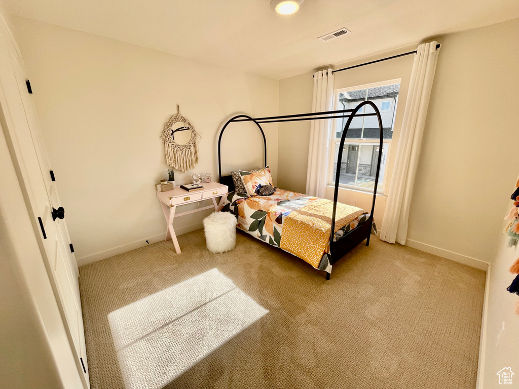 Bedroom with light carpet and baseboards