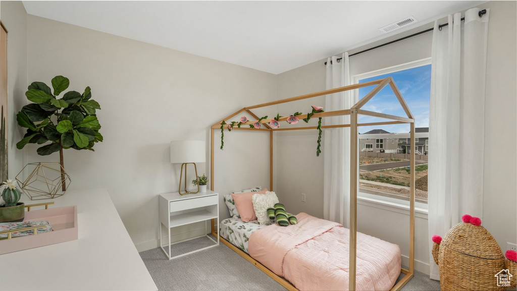 Bedroom featuring light carpet and baseboards
