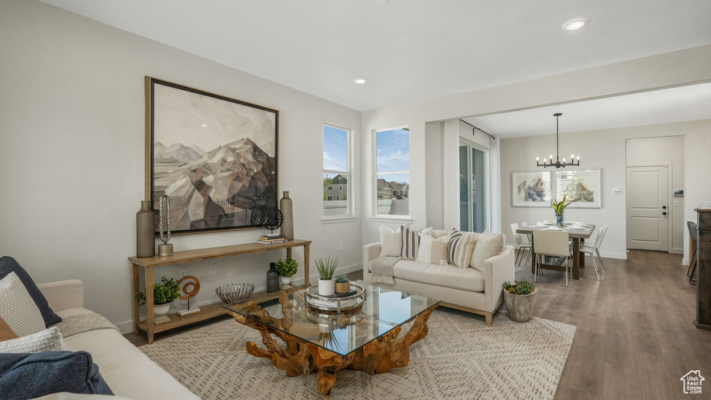 Living area featuring a chandelier, wood finished floors, and recessed lighting