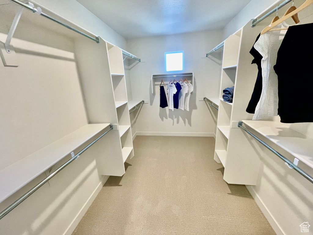 Walk in closet with light carpet