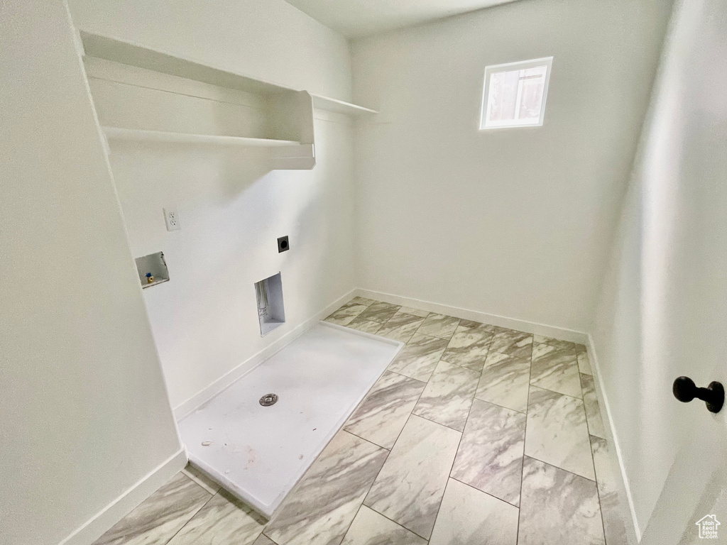 Washroom with light marble finish floors, hookup for a washing machine, and electric dryer hookup