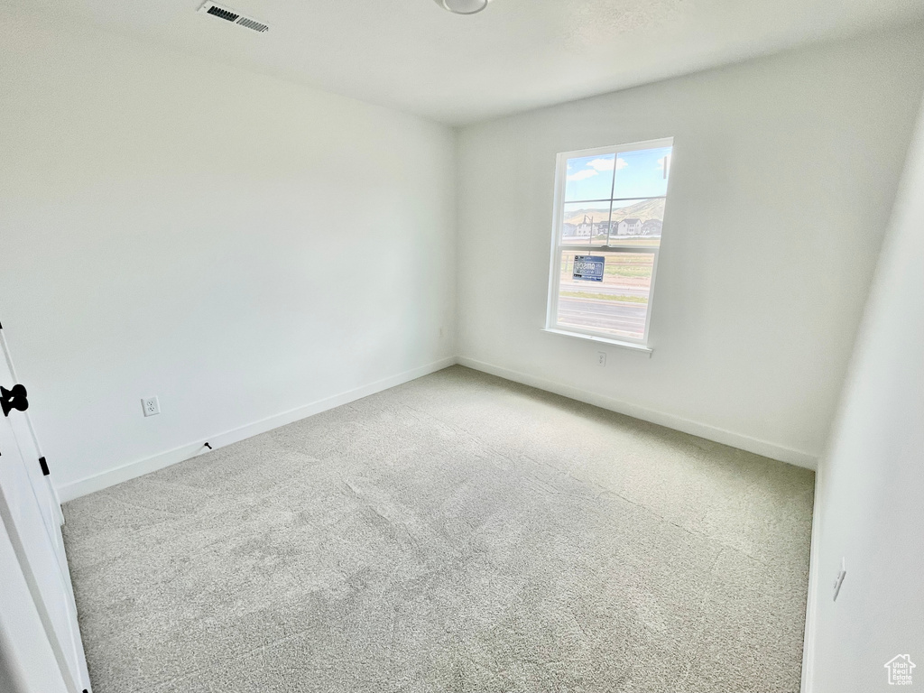 Empty room with carpet and baseboards