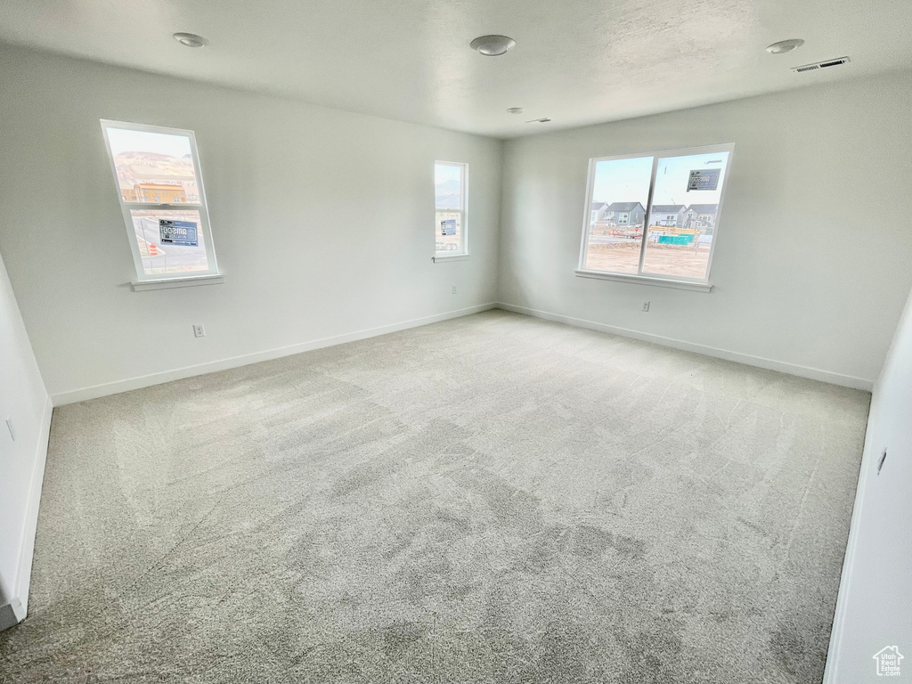 Unfurnished room with carpet