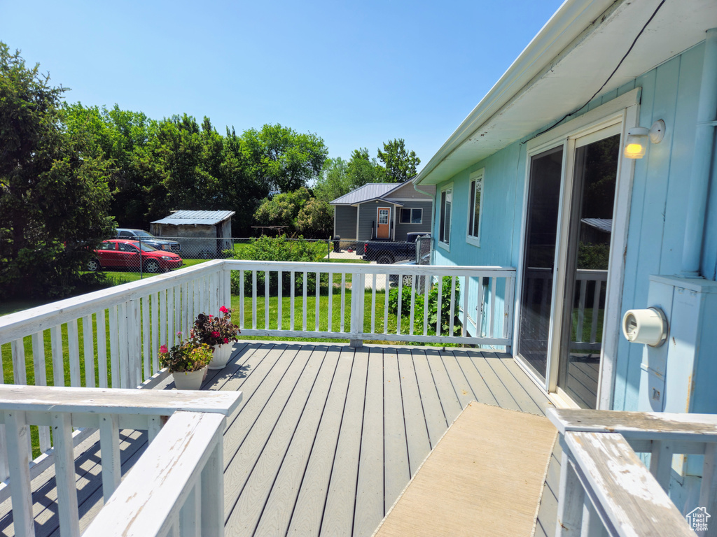 Wooden deck featuring a lawn
