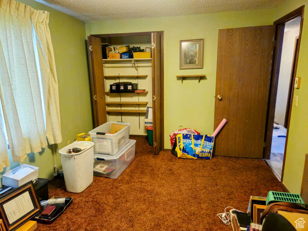 Bedroom featuring carpet floors and a textured ceiling