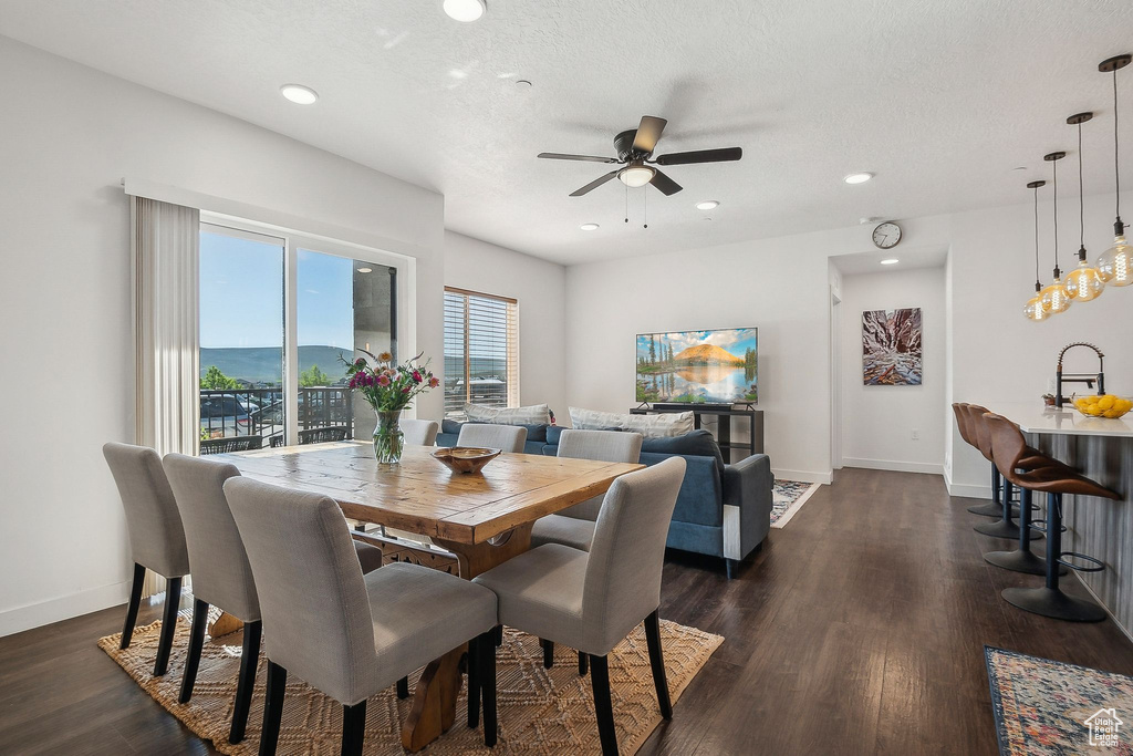 Dining room featuring a ceiling fan, baseboards, dark wood-type flooring, and recessed lighting