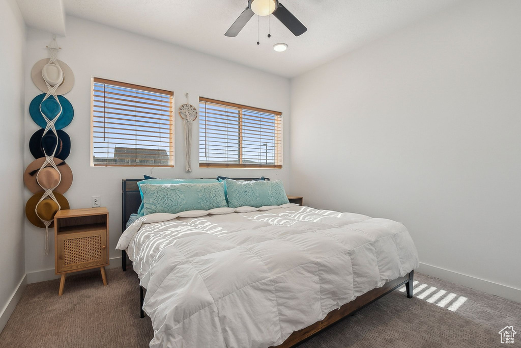 Carpeted bedroom with baseboards and ceiling fan