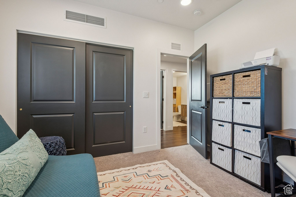Sitting room with carpet floors and baseboards