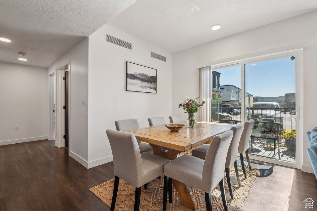 Dining area featuring wood finished floors, baseboards, and recessed lighting