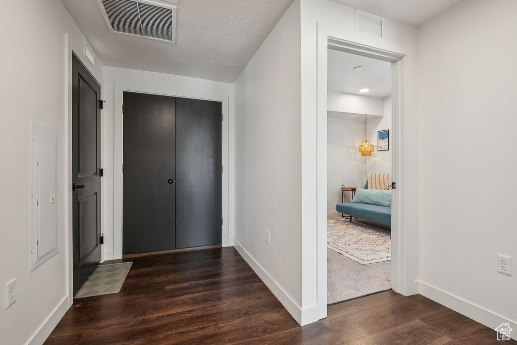 Foyer entrance with wood finished floors and baseboards