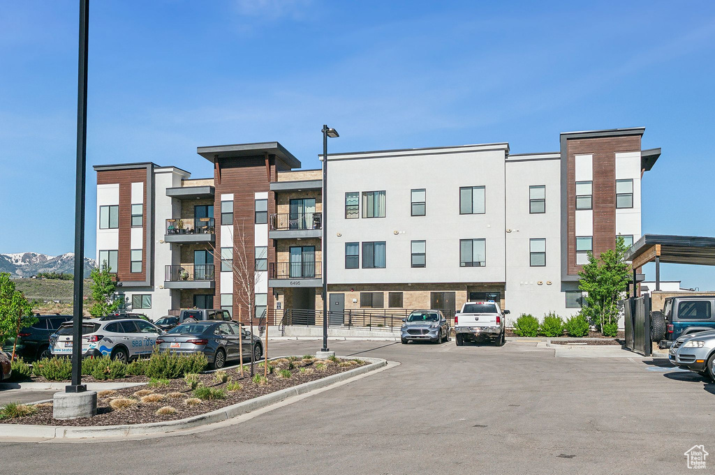 View of property featuring uncovered parking