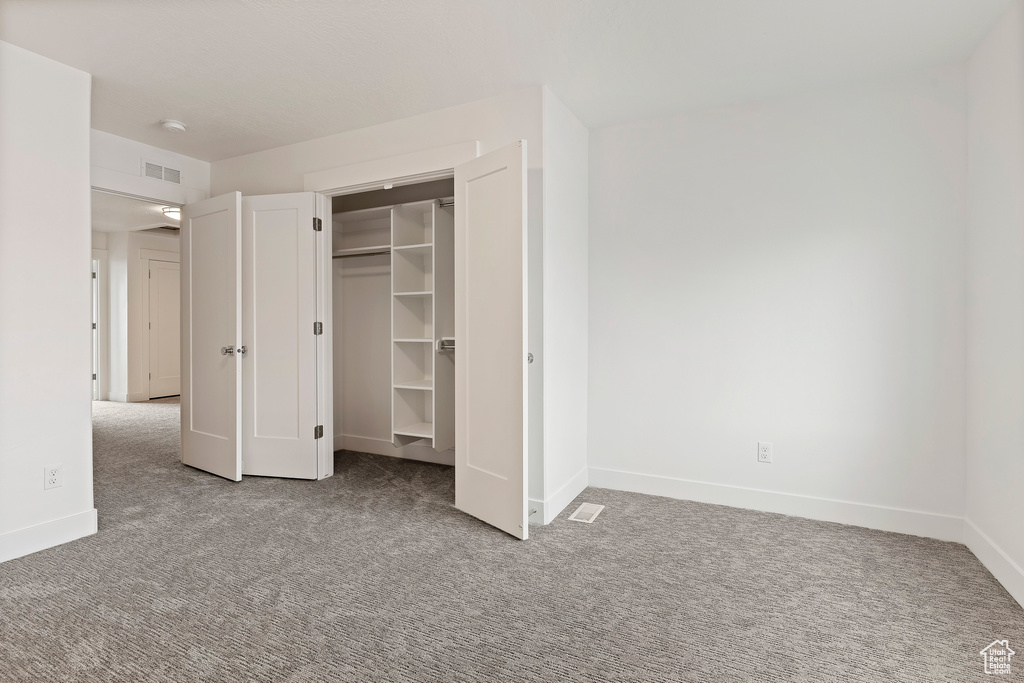 Unfurnished bedroom featuring carpet flooring and baseboards