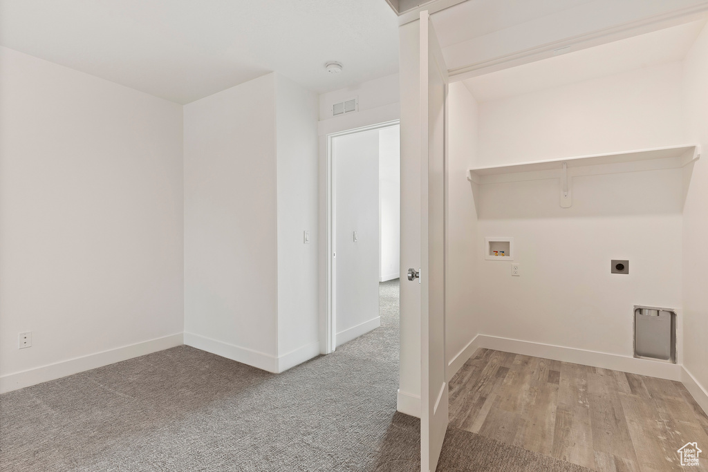 Washroom featuring electric dryer hookup, hookup for a washing machine, baseboards, and carpet floors