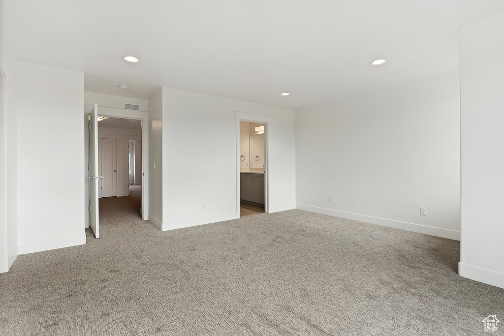 Carpeted spare room featuring baseboards and recessed lighting