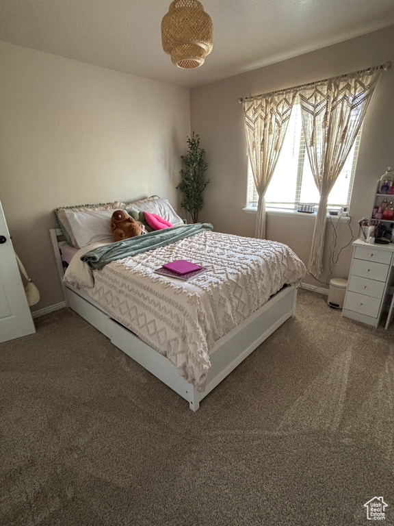 Bedroom featuring light colored carpet