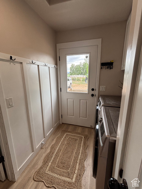 Laundry room featuring washer and dryer and light wood-type flooring