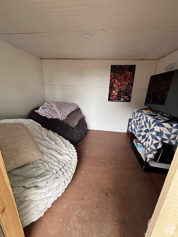 Bedroom with concrete flooring