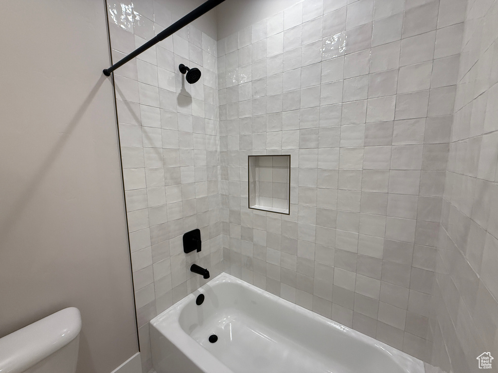 Full bathroom featuring toilet and tub / shower combination