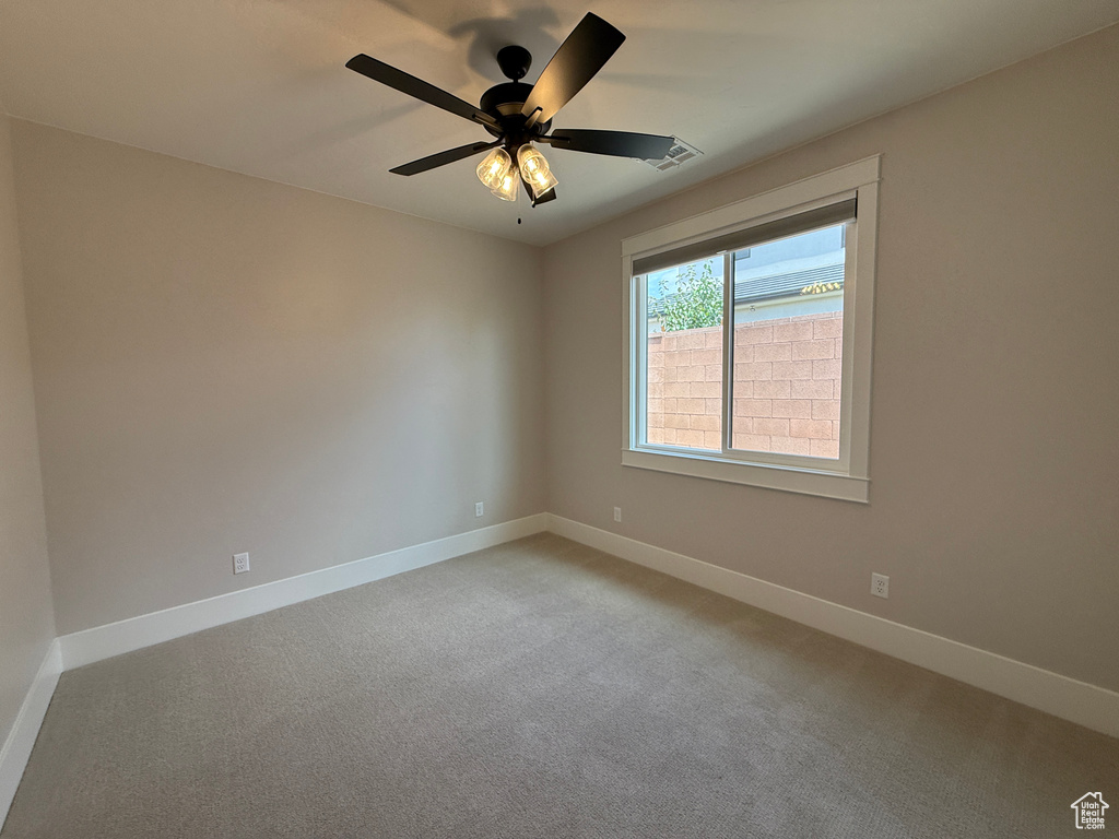 Spare room featuring baseboards and light colored carpet