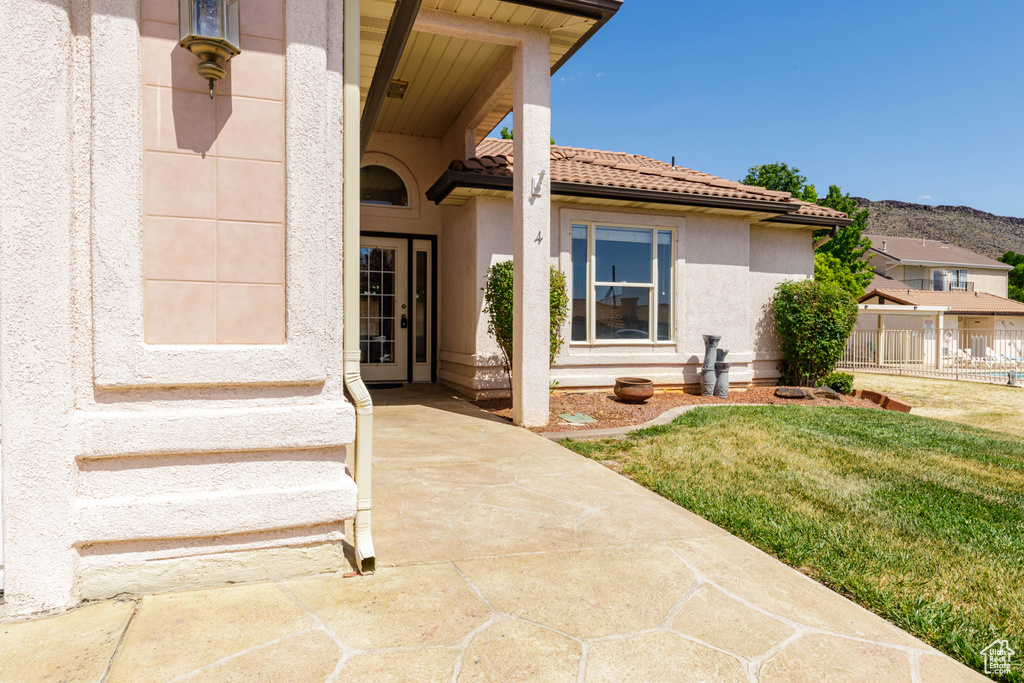Doorway to property with stucco siding and a tiled roof