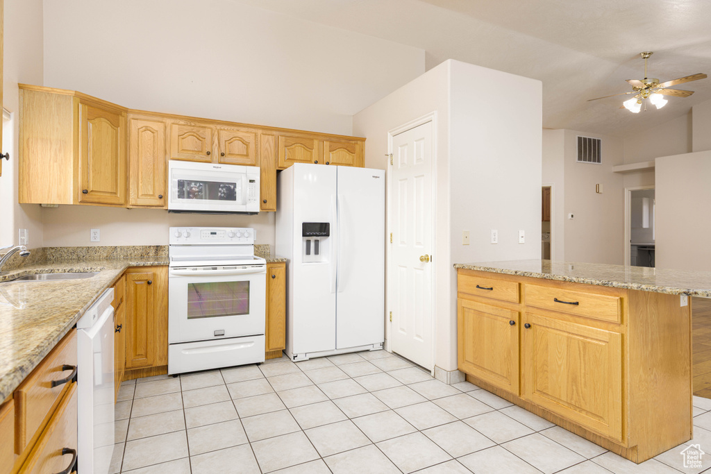 Kitchen featuring white appliances, a sink, a peninsula, ceiling fan, and lofted ceiling