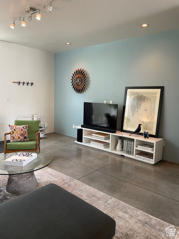 Living room with concrete flooring and recessed lighting