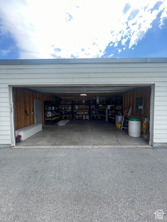 Garage featuring asphalt driveway