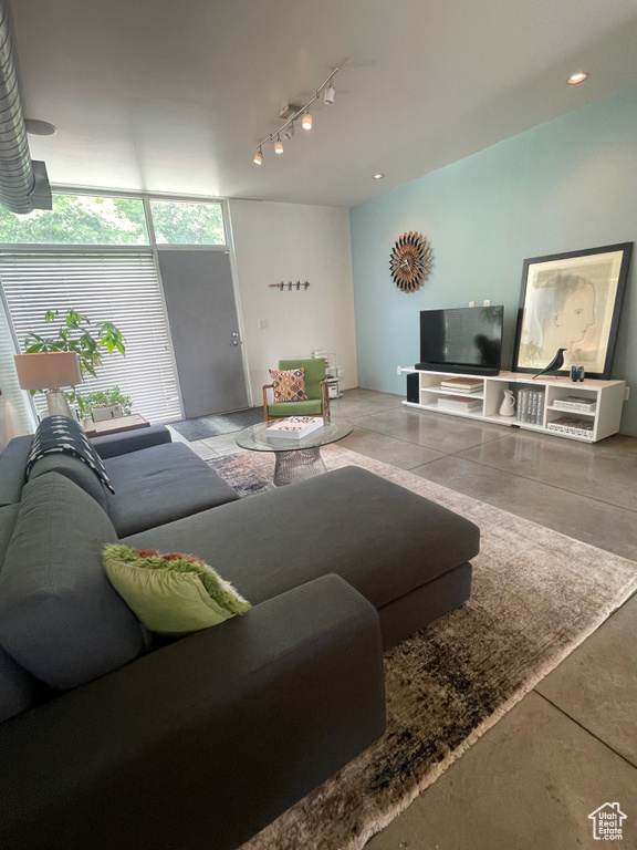Living room with rail lighting and concrete floors