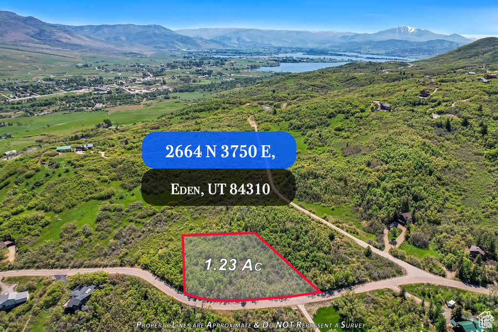 Aerial overview of property's location featuring property boundaries highlighted and a water and mountain view