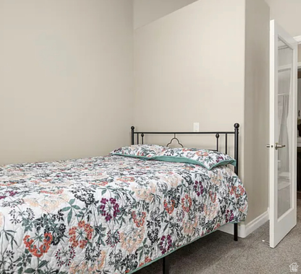 Carpeted bedroom with baseboards