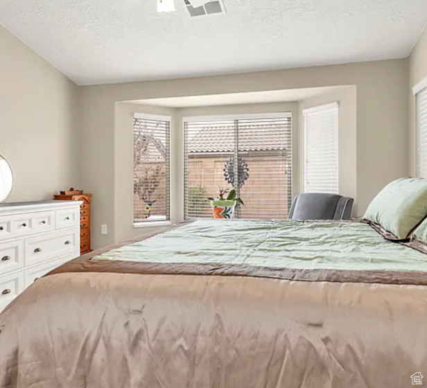 Bedroom with a textured ceiling