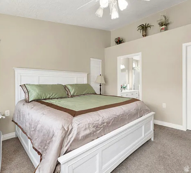 Bedroom featuring light carpet, baseboards, and ceiling fan