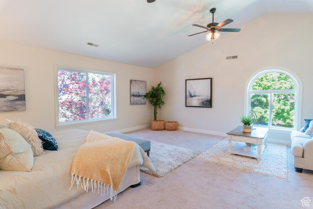 Carpeted bedroom with vaulted ceiling, baseboards, and ceiling fan