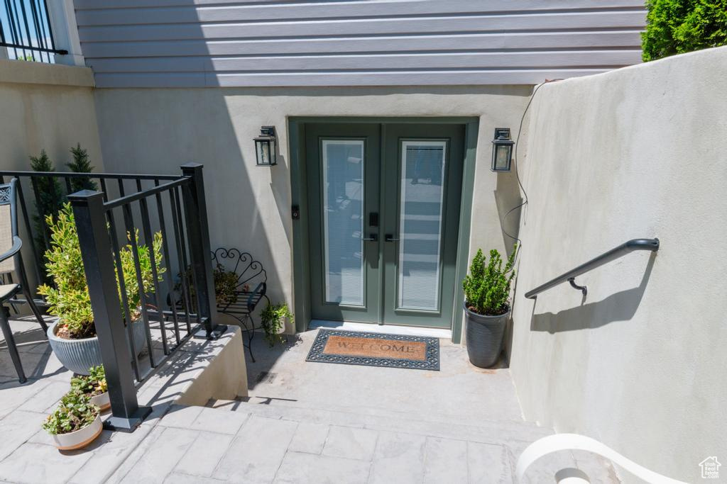 Entrance to property with stucco siding and french doors