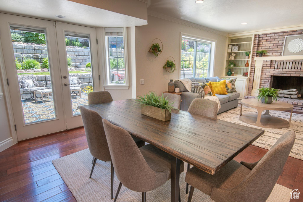 Dining area featuring healthy amount of natural light, crown molding, hardwood / wood-style flooring, french doors, and recessed lighting