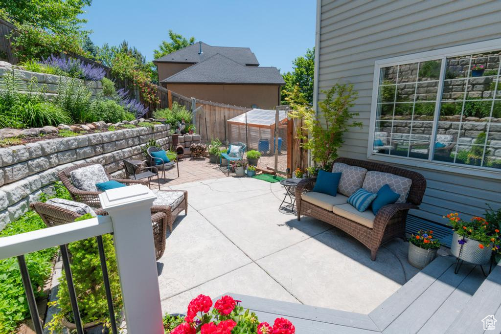 Fenced backyard featuring a patio area and an outdoor hangout area