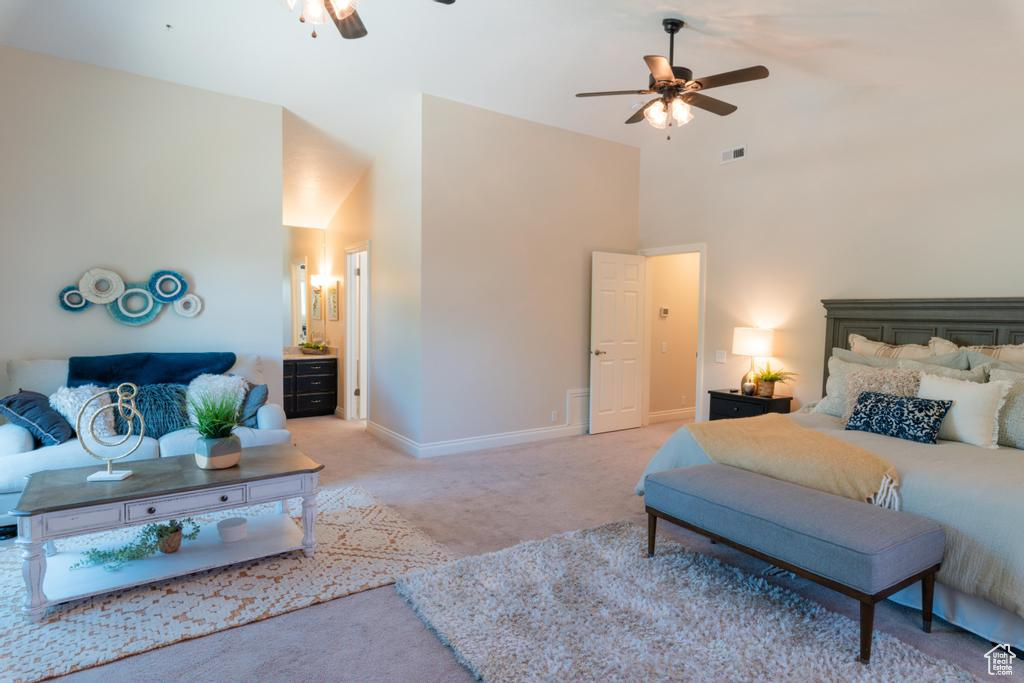 Carpeted bedroom featuring high vaulted ceiling, baseboards, ceiling fan, and connected bathroom