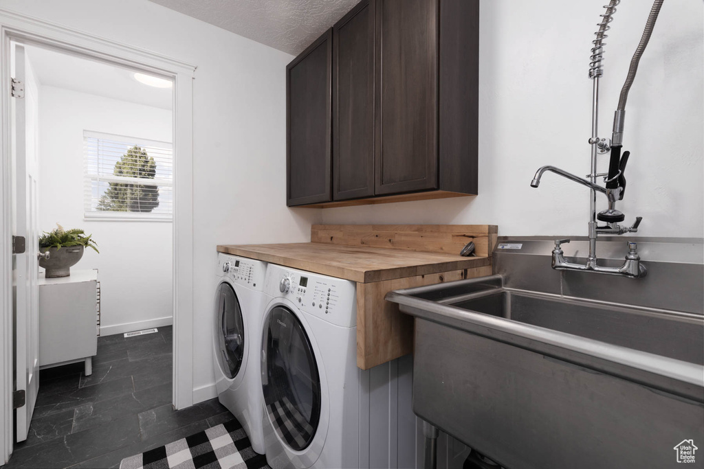 Washroom with washing machine and clothes dryer and cabinet space