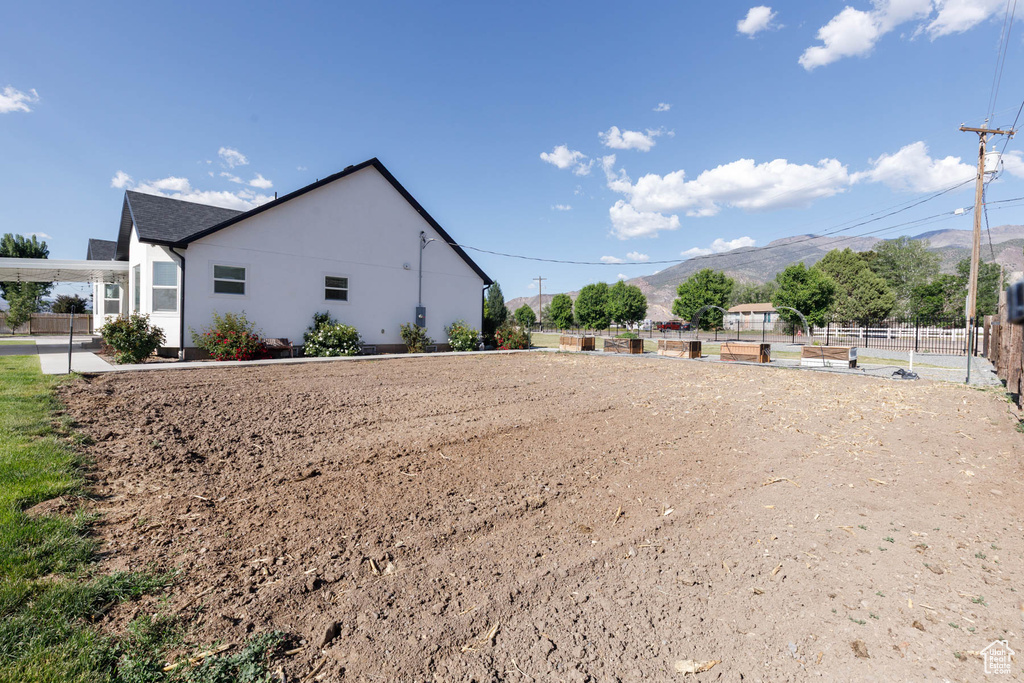 View of side of home featuring a mountain view and stucco siding