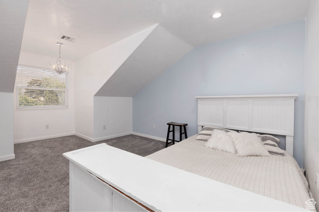 Bedroom featuring a chandelier, dark carpet, lofted ceiling, baseboards, and recessed lighting
