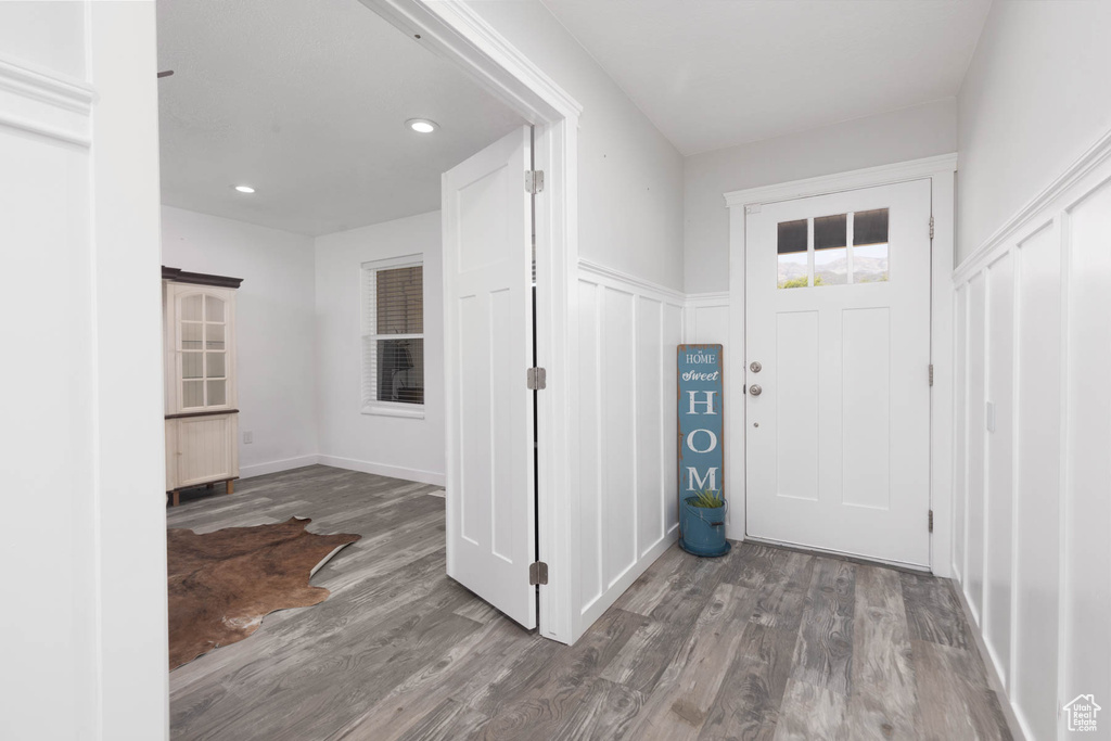Entryway featuring wood finished floors, recessed lighting, and a barn door