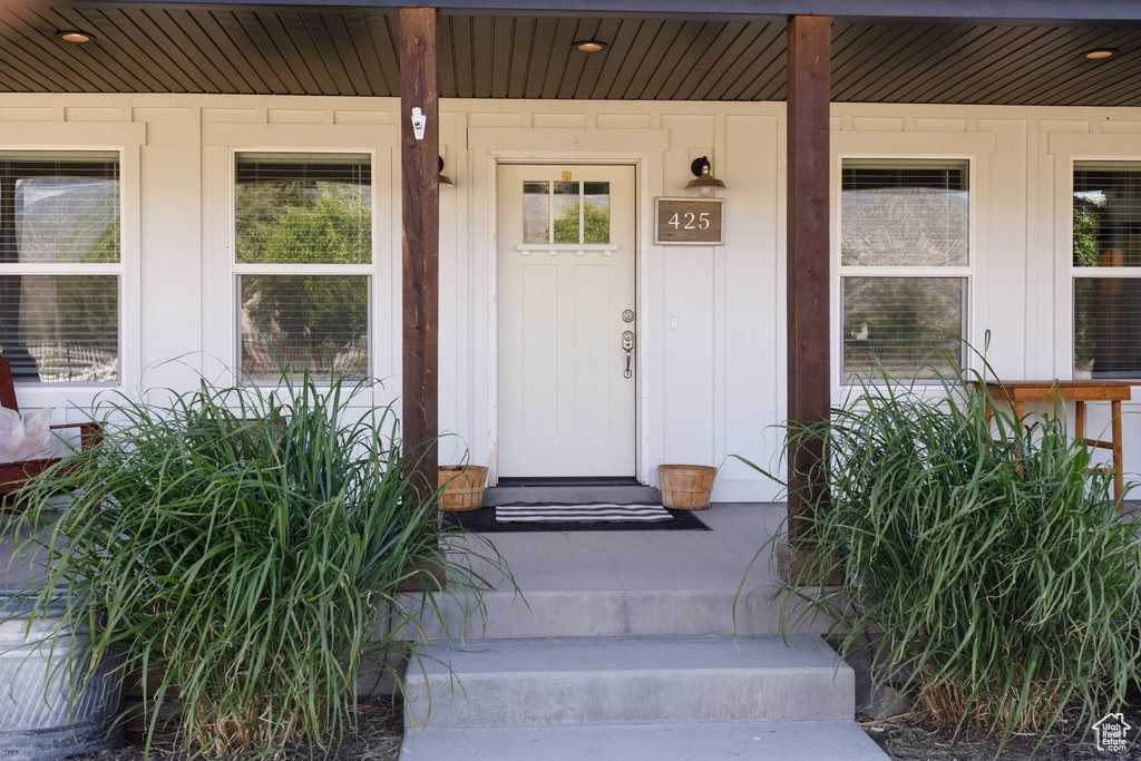 Property entrance featuring a porch and board and batten siding