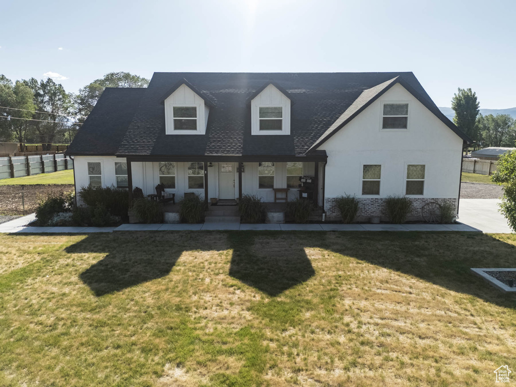 Cape cod-style house with covered porch