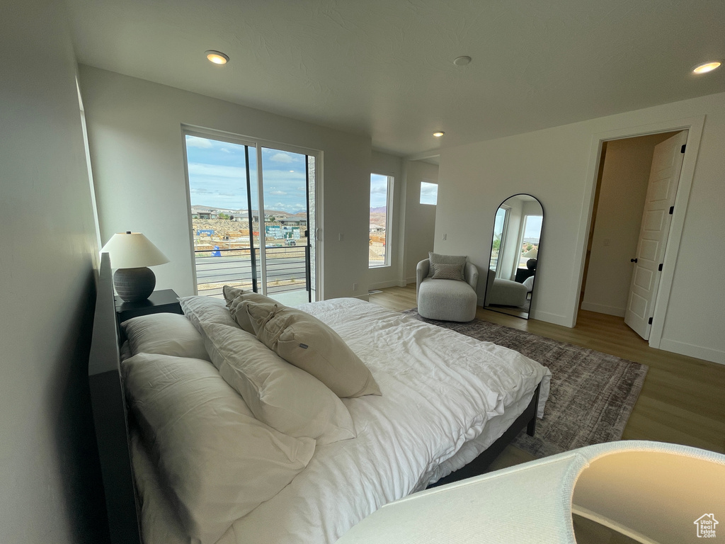 Bedroom featuring light wood-style floors, access to outside, recessed lighting, and baseboards