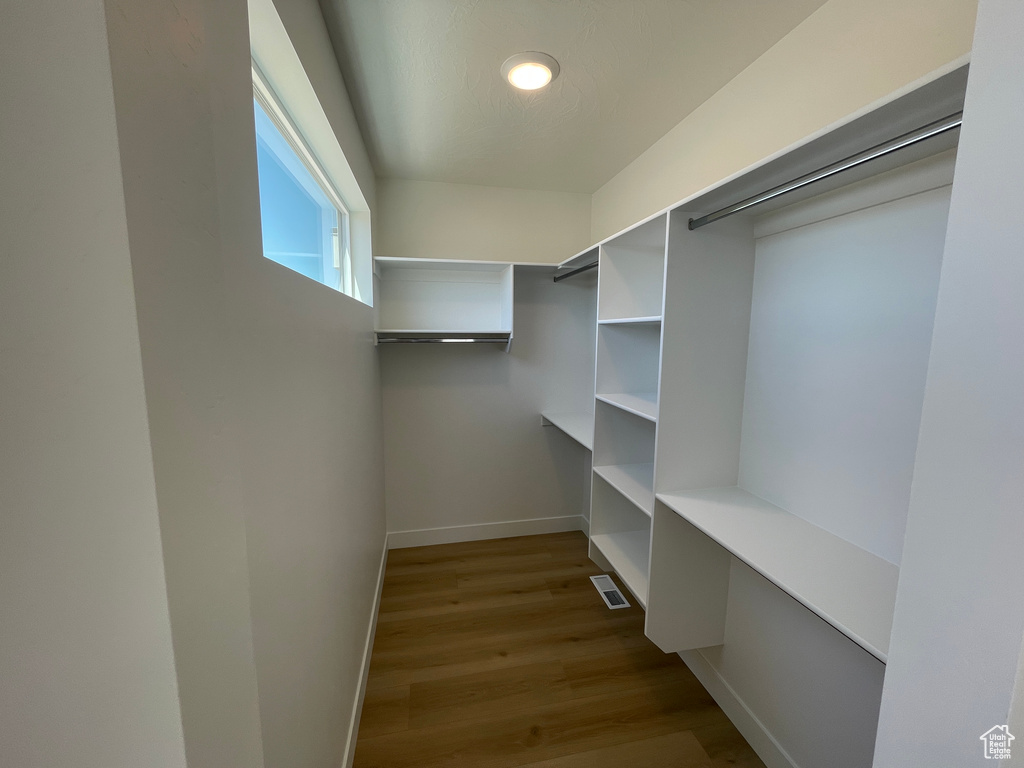 Spacious closet with wood finished floors